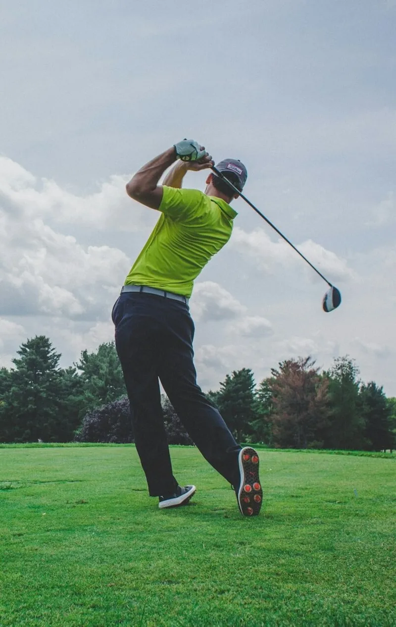 Golfer preparing for tee shot on professional golf course